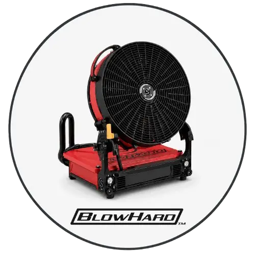 BlowHard portable ventilation solution operating during a training exercise, controlled smoke being pushed away from an entry point, firefighters practicing tactical ventilation, strong airflow effect, reliable and rugged firefighting equipment concept.